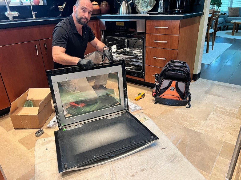 Built-in oven door repair — technician on site